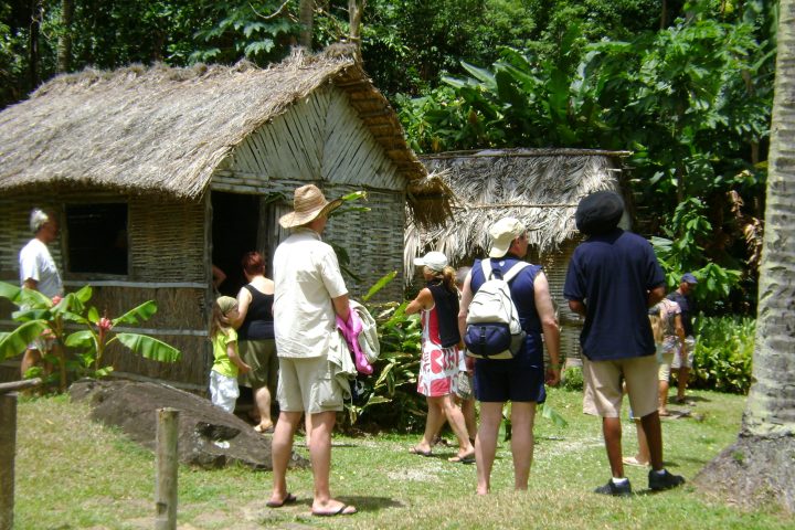 a group of people standing in front of a house
