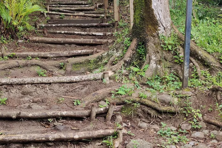 a sign on a dirt road