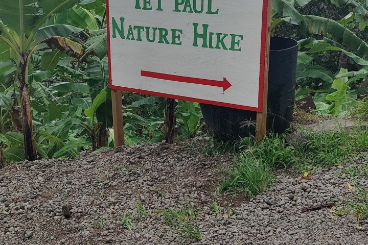 a sign on a dirt road