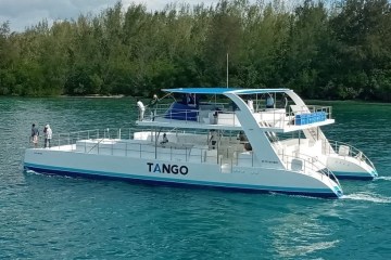 a blue and white boat floating on a body of water