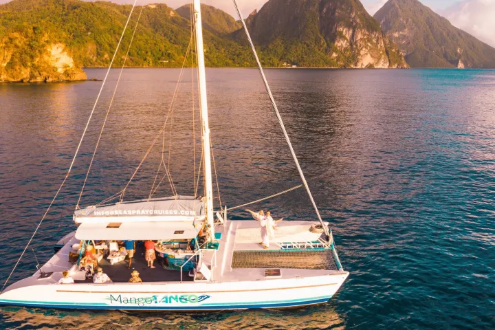 a small boat in a body of water with a mountain in the background