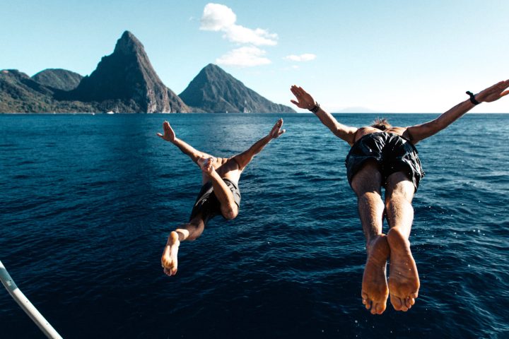 a group of people standing next to a body of water