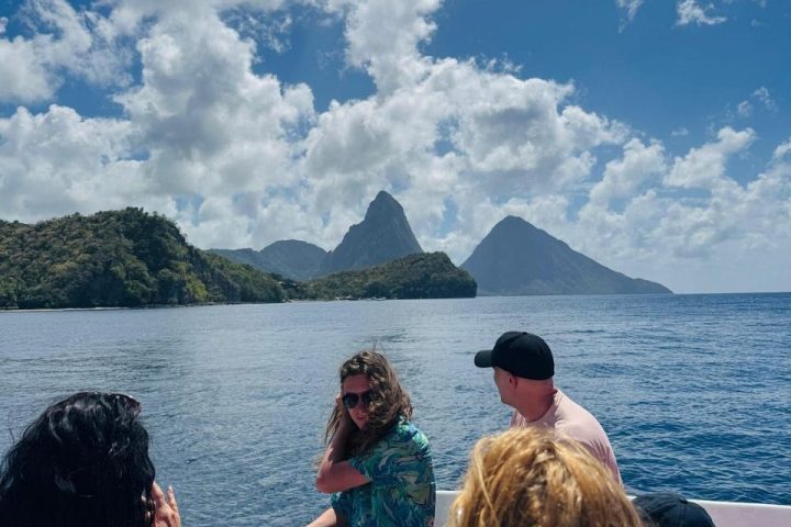 a group of people standing next to a body of water with Lake Atitlán in the background